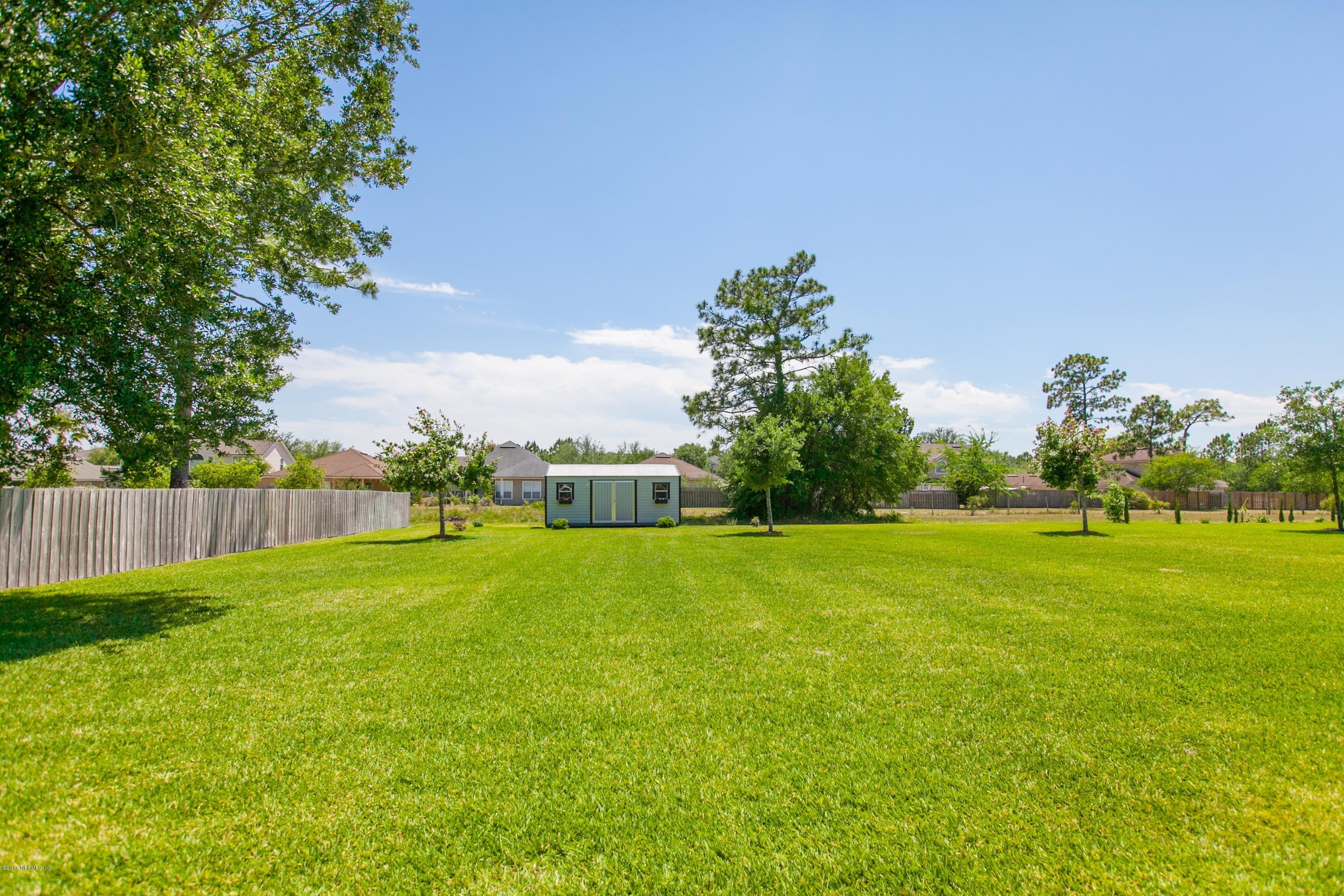 490 Irish Rose Road St. Augustine, FL 32092 - Photo 33 of 44 a view of a field of grass and trees