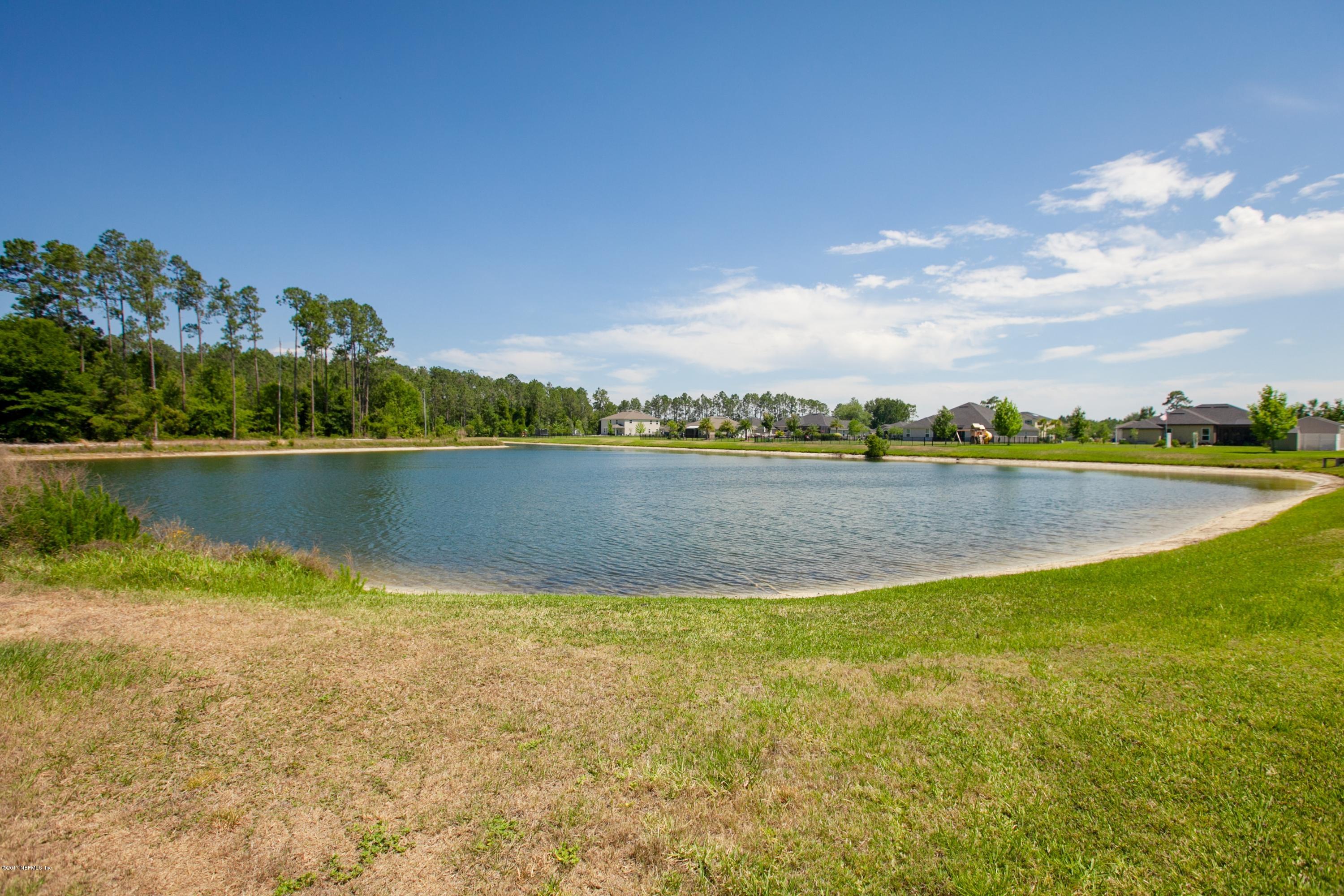 490 Irish Rose Road St. Augustine, FL 32092 - Photo 42 of 44 a view of a lake with houses in the background