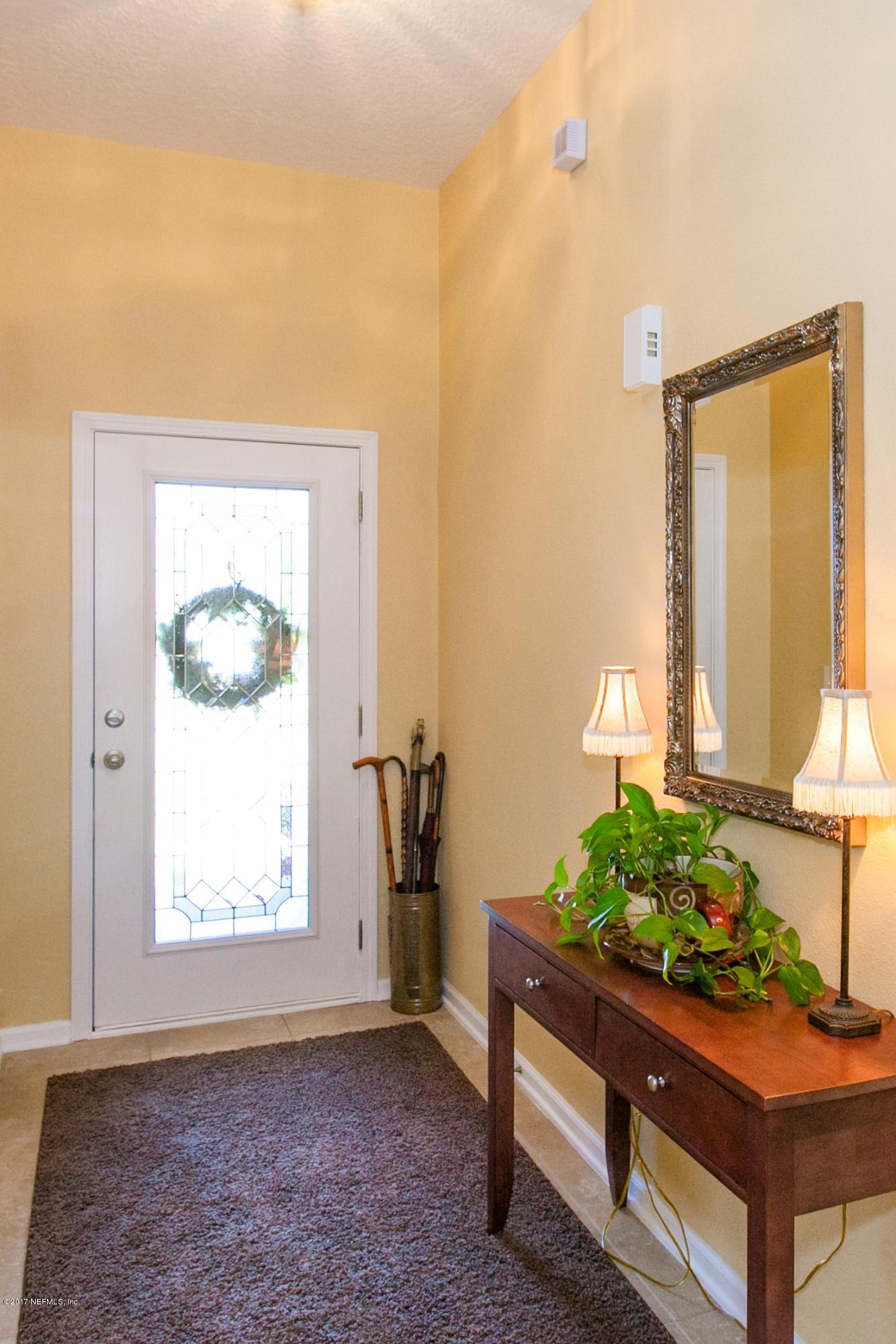 490 Irish Rose Road St. Augustine, FL 32092 - Photo 6 of 44 a wooden bench sitting in front of a window