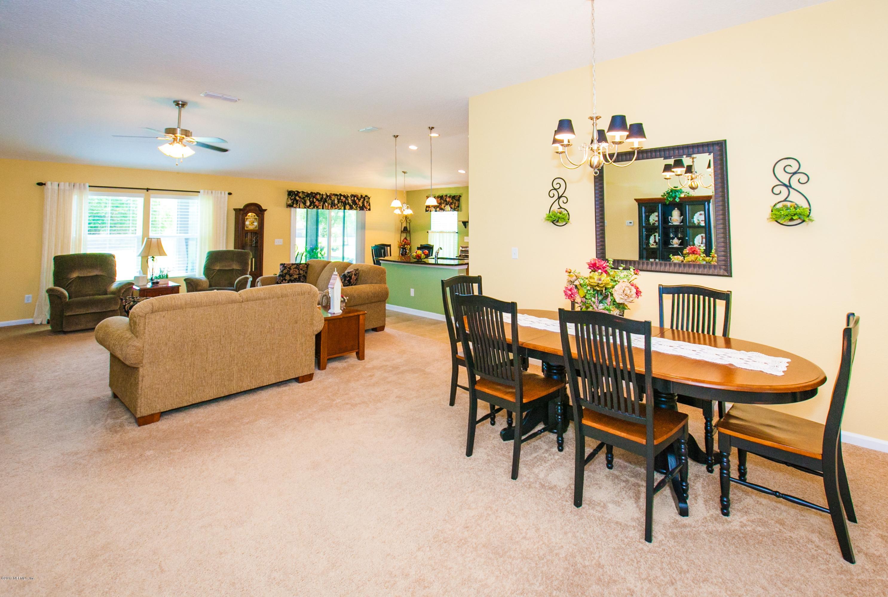 490 Irish Rose Road St. Augustine, FL 32092 - Photo 7 of 44 a living room with furniture and a large window