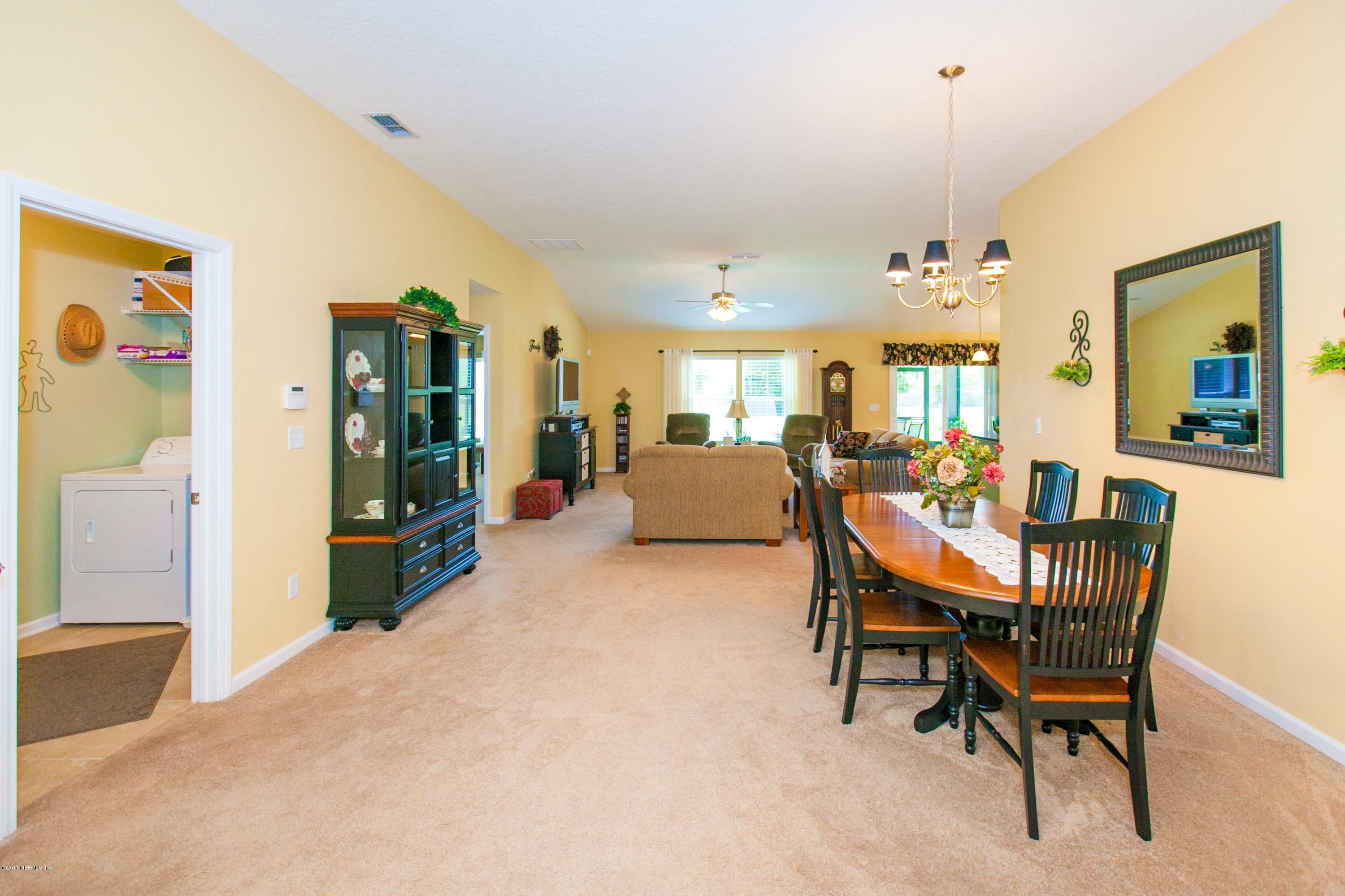490 Irish Rose Road St. Augustine, FL 32092 - Photo 8 of 44 a view of a livingroom with furniture and a dining table