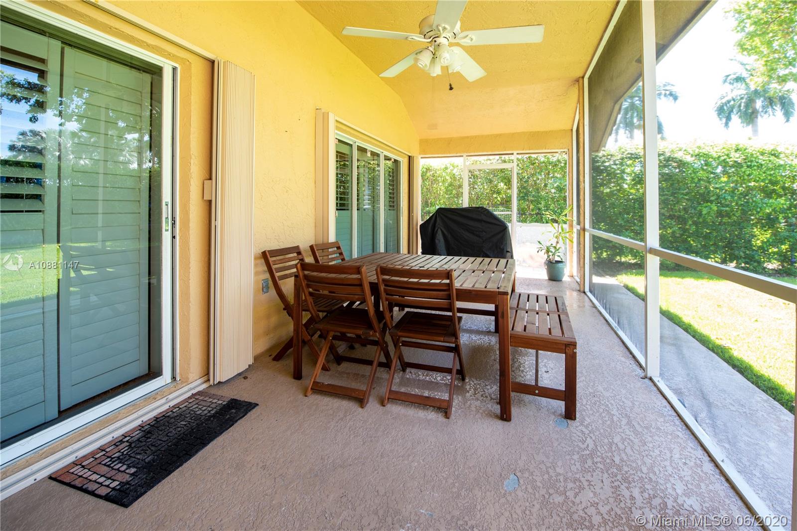 12346 Baywind Court Boca Raton, FL 33428 - Photo 25 of 31 a dining room with furniture and a floor to ceiling window