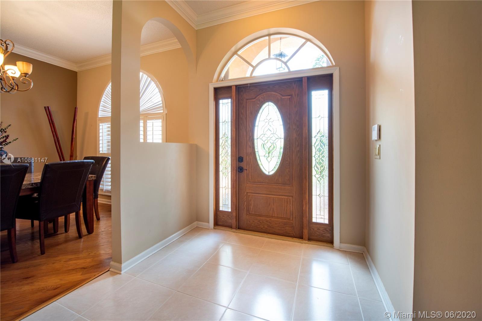 12346 Baywind Court Boca Raton, FL 33428 - Photo 3 of 31 an empty room with wooden floor mirror and windows
