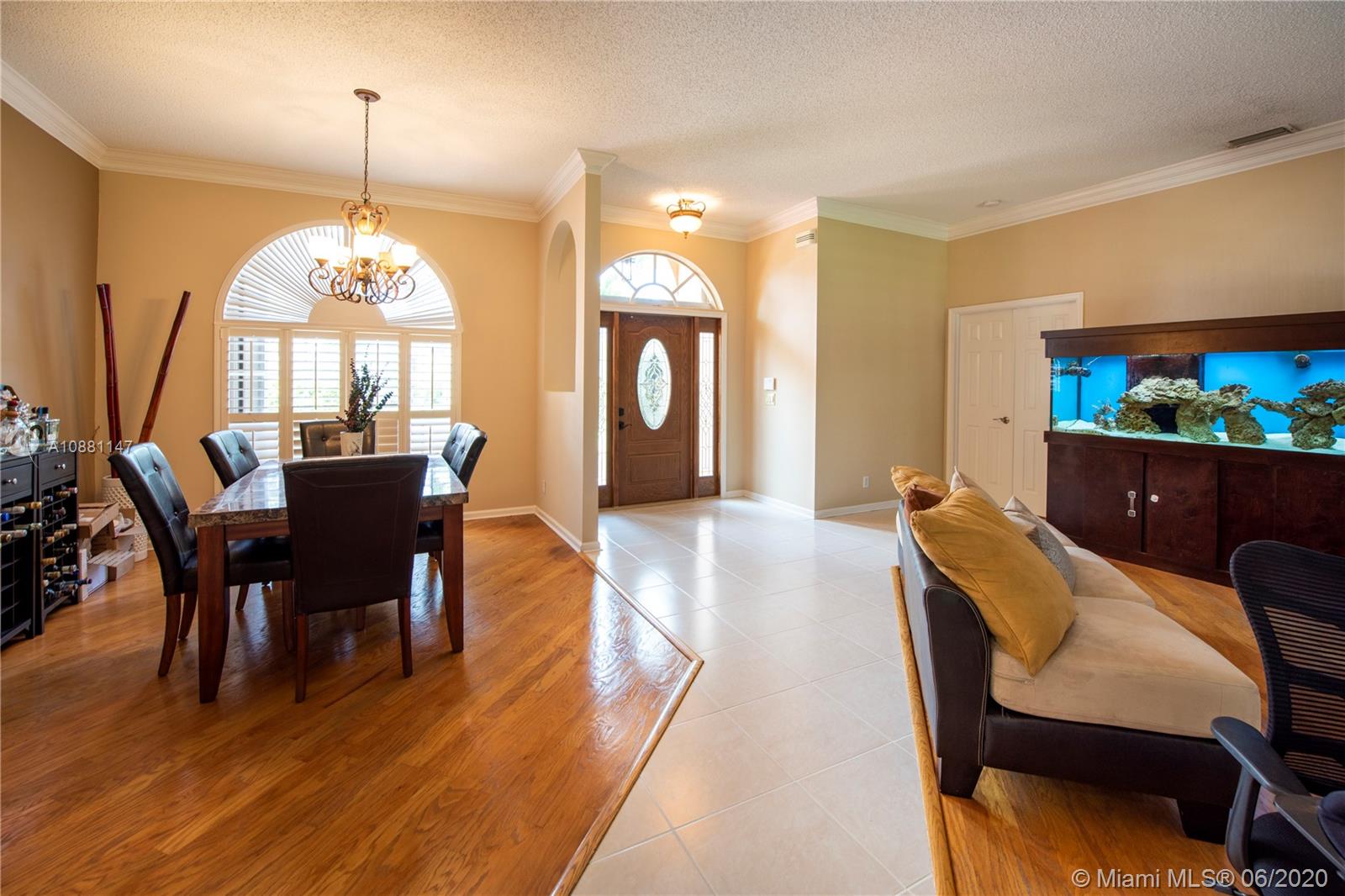 12346 Baywind Court Boca Raton, FL 33428 - Photo 4 of 31 a view of a dining room with furniture and a chandelier