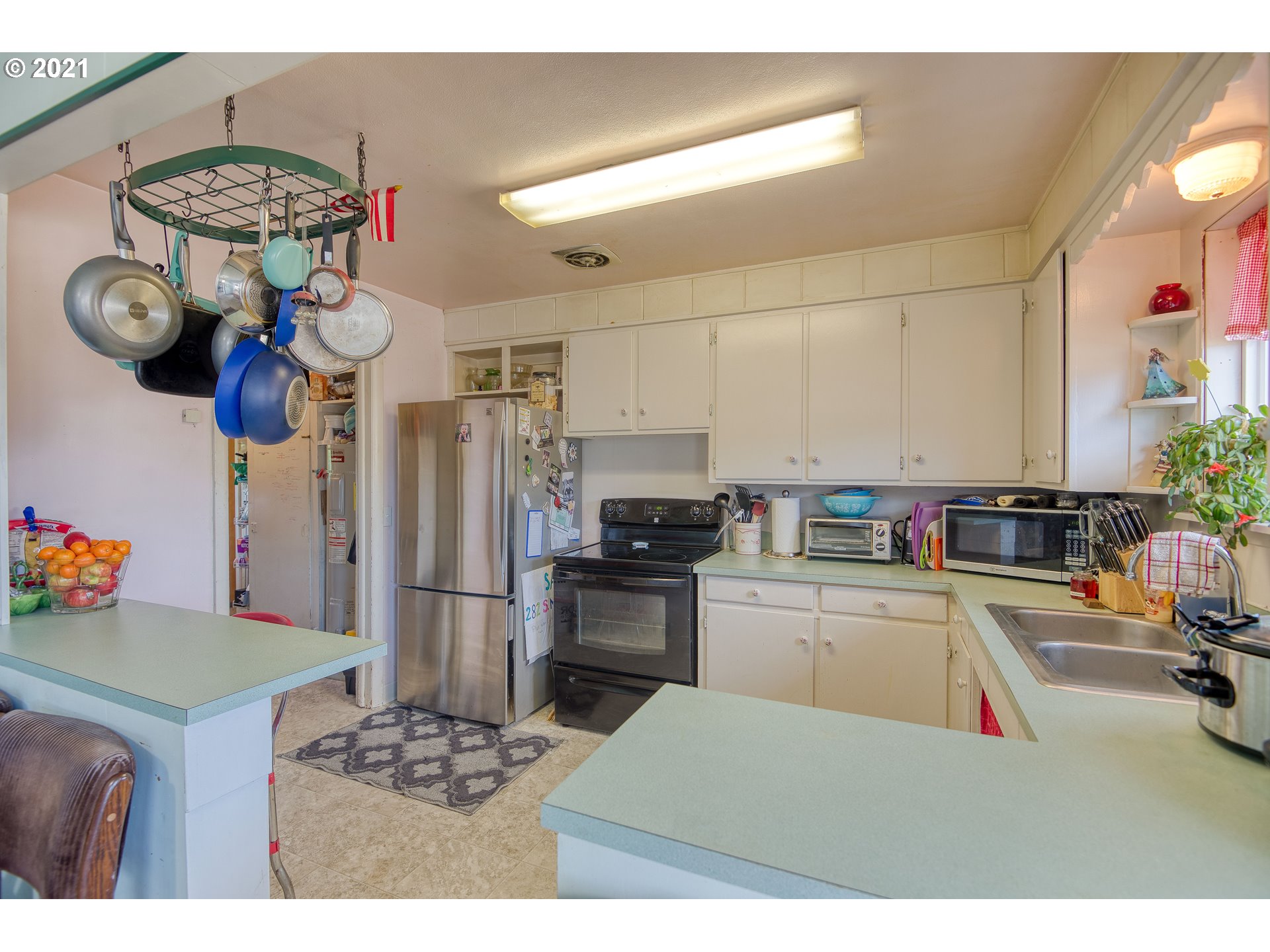 282 South Morrison Street Coos Bay, OR 97420 - Photo 12 of 29 a kitchen with stainless steel appliances granite countertop a sink dishwasher stove and refrigerator