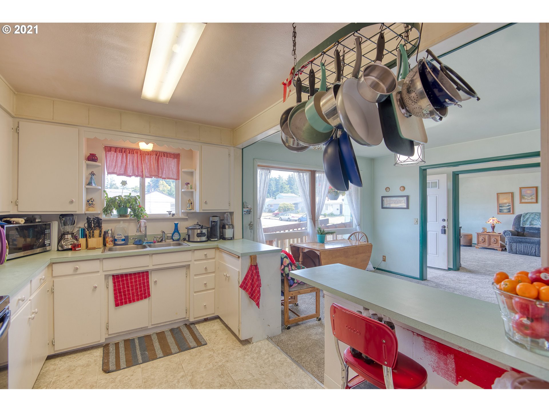 282 South Morrison Street Coos Bay, OR 97420 - Photo 13 of 29 a kitchen with stainless steel appliances granite countertop a sink dishwasher and cabinets with wooden floor