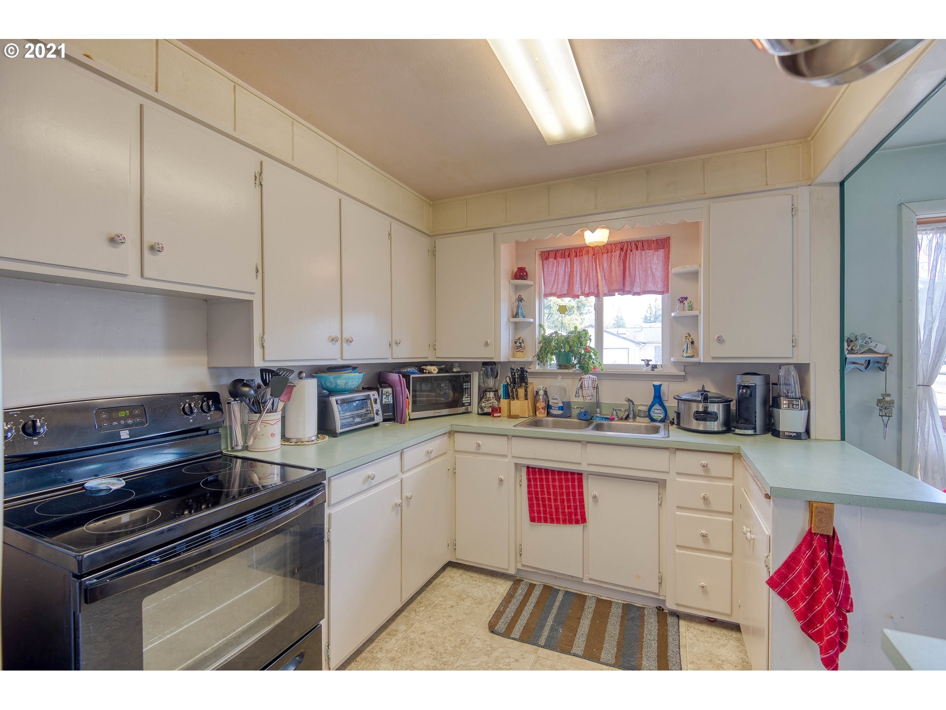 282 South Morrison Street Coos Bay, OR 97420 - Photo 14 of 29 a kitchen with granite countertop a stove sink and cabinets