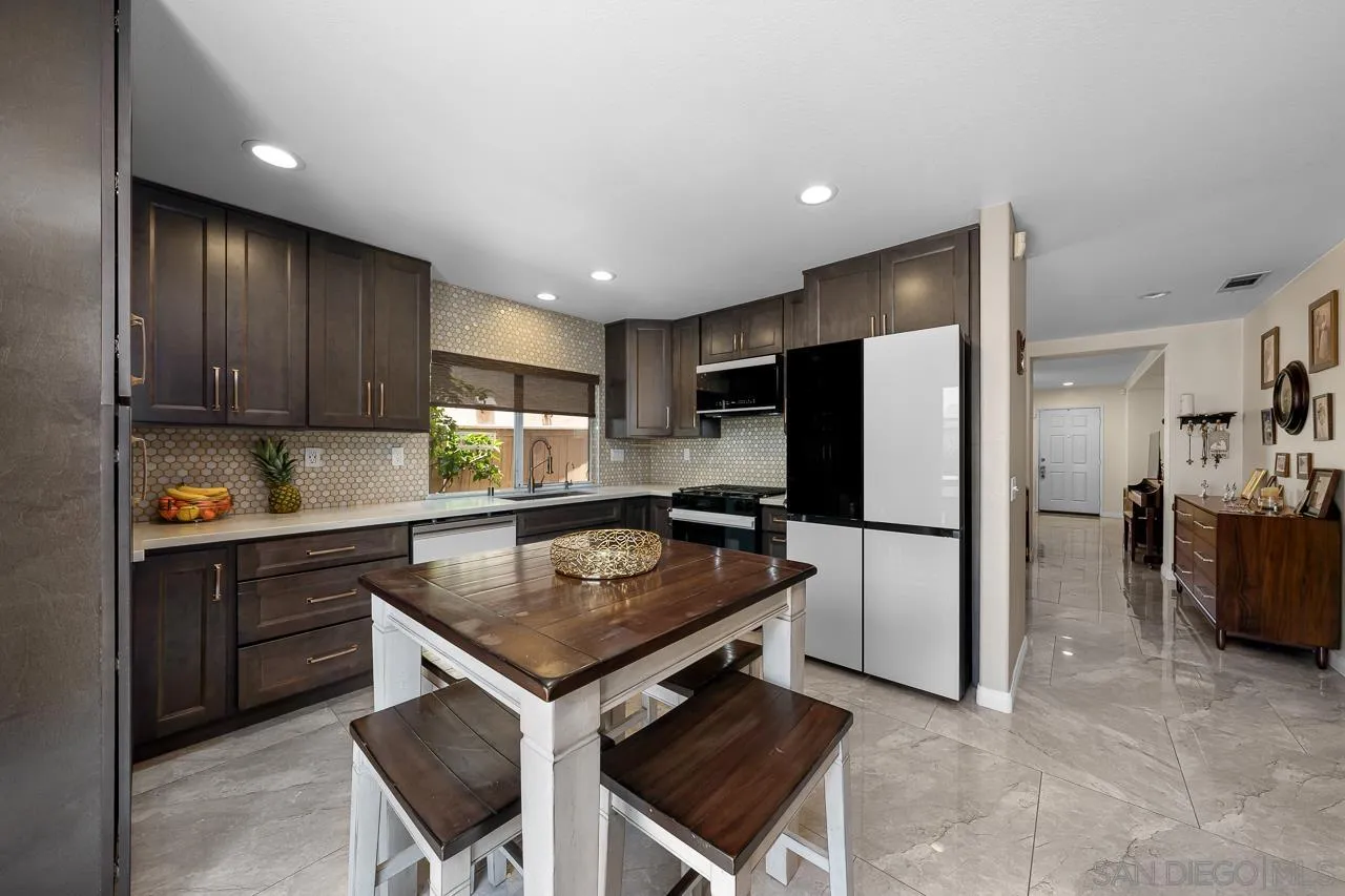 1631 Applegate Street Chula Vista, CA 91913 - Photo 16 of 34 a kitchen with refrigerator and cabinets