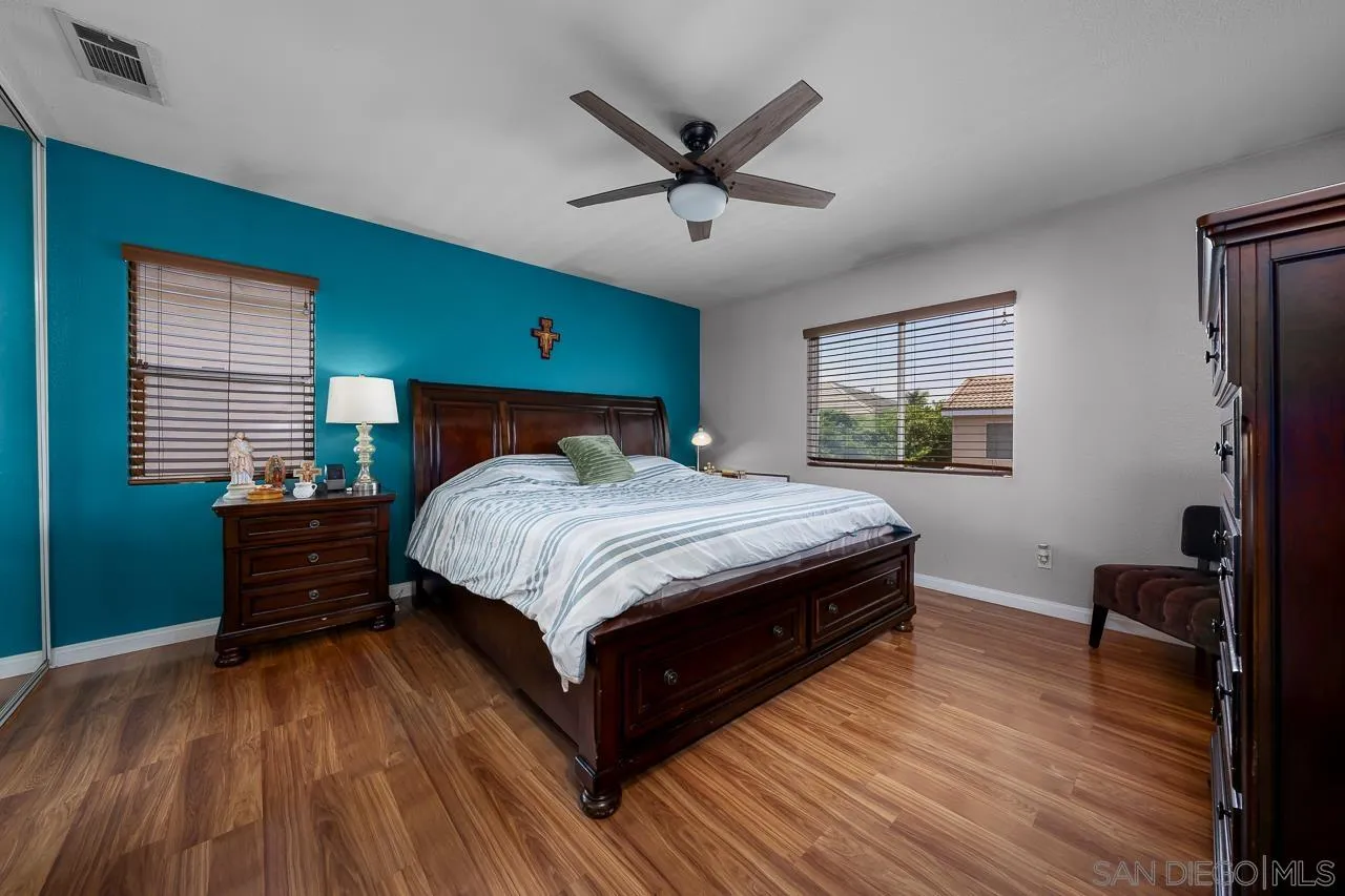 1631 Applegate Street Chula Vista, CA 91913 - Photo 31 of 34 a bedroom with a bed and wooden floor