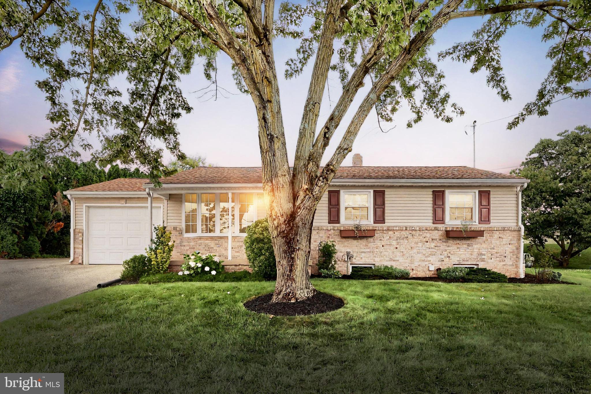 2569 Emig Mill Road Dover, PA 17315 - Photo 1 of 32 a front view of a house with a garden and trees