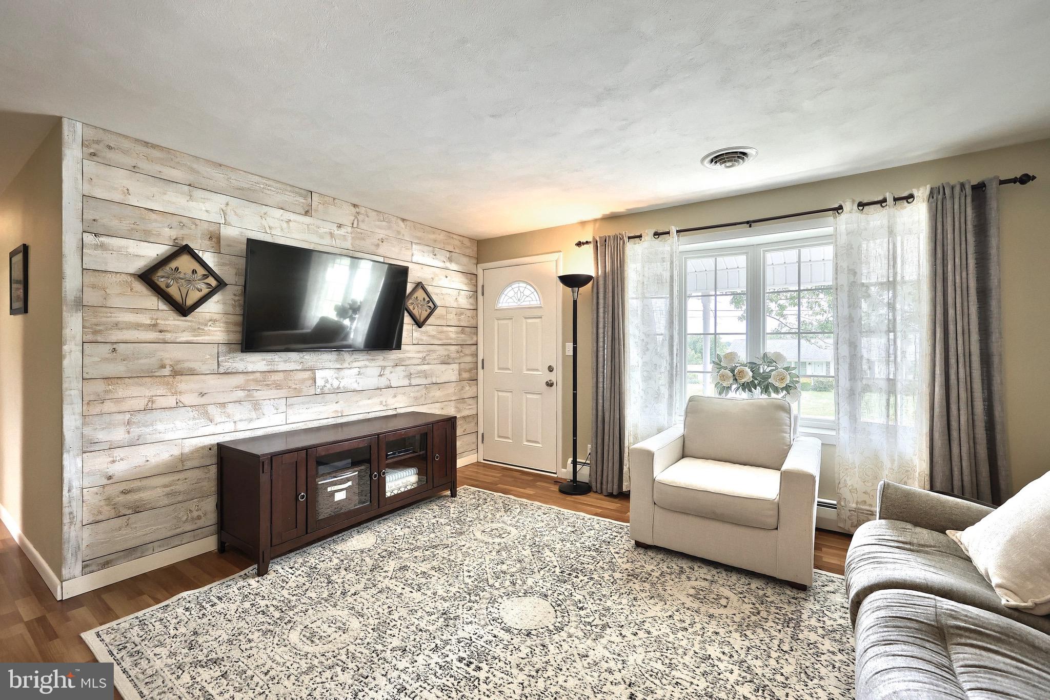 2569 Emig Mill Road Dover, PA 17315 - Photo 12 of 32 a living room with furniture and a flat screen tv