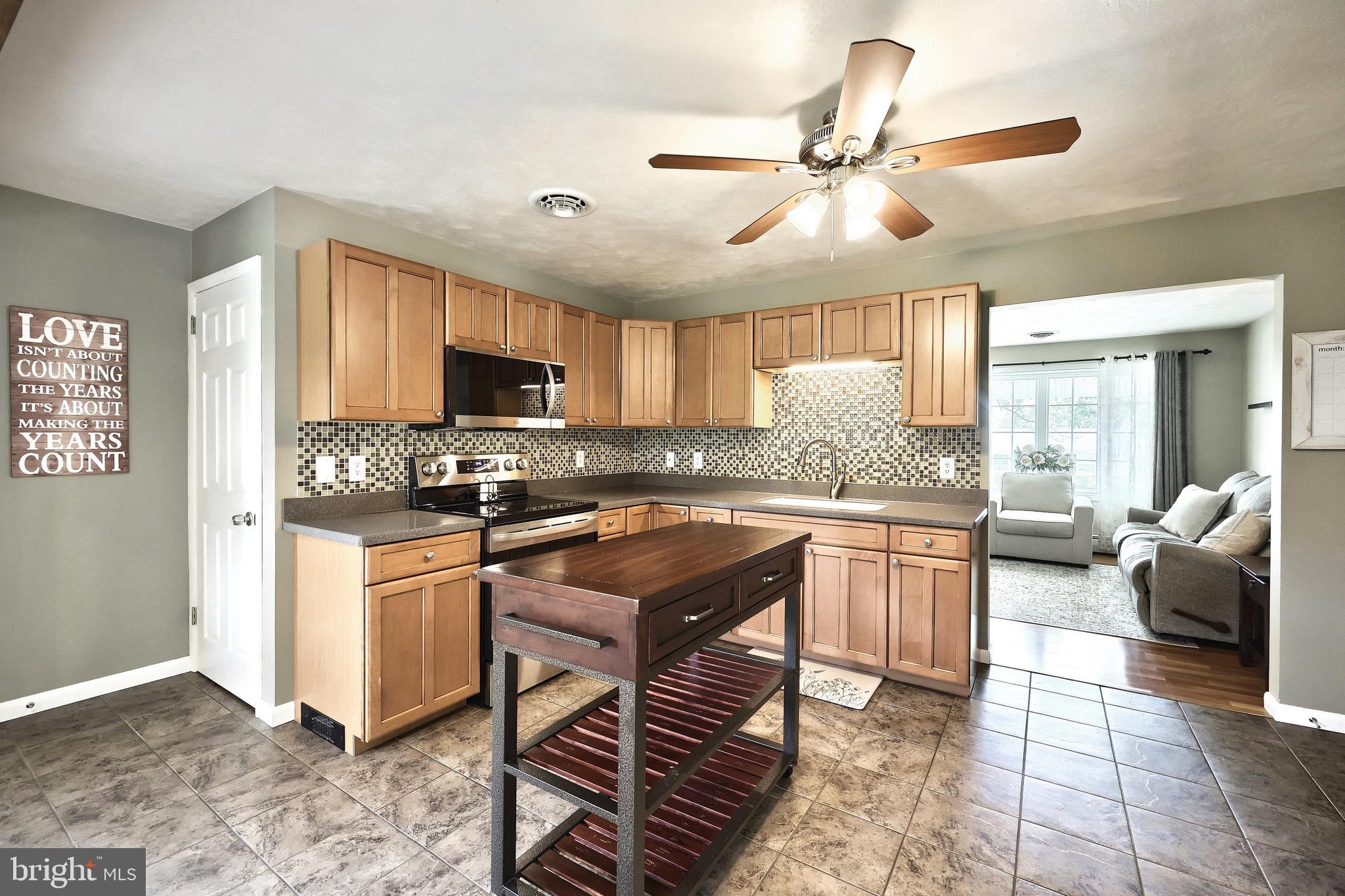 2569 Emig Mill Road Dover, PA 17315 - Photo 15 of 32 a kitchen with stainless steel appliances granite countertop a stove refrigerator and cabinets