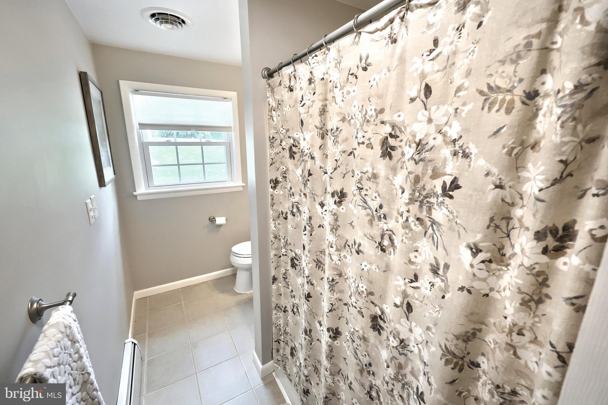 2569 Emig Mill Road Dover, PA 17315 - Photo 16 of 32 a bathroom with a toilet and a shower curtain