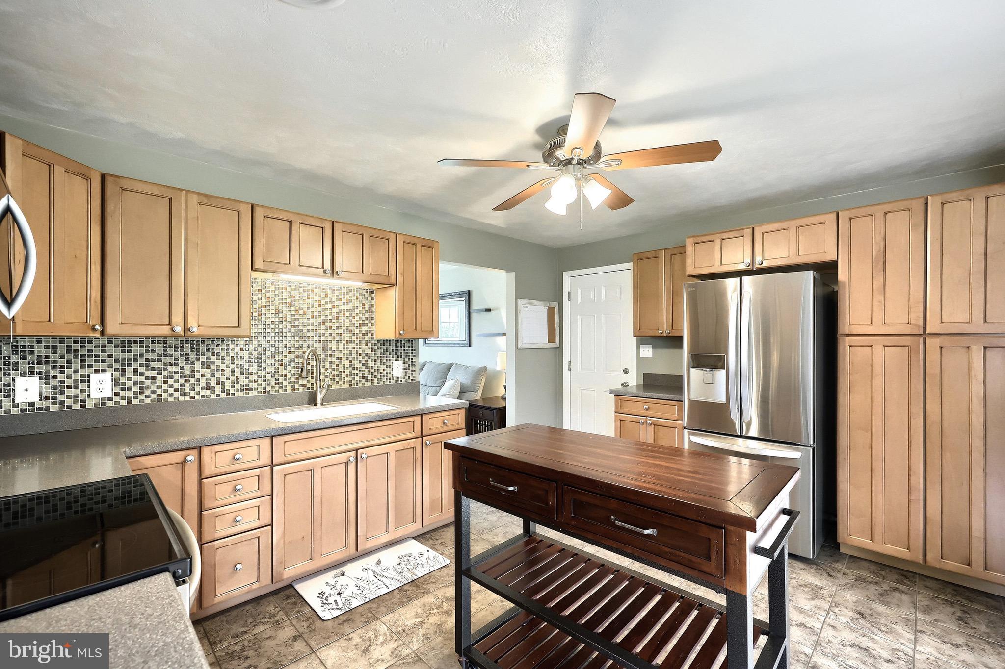 2569 Emig Mill Road Dover, PA 17315 - Photo 20 of 32 a kitchen with stainless steel appliances granite countertop a stove refrigerator and cabinets