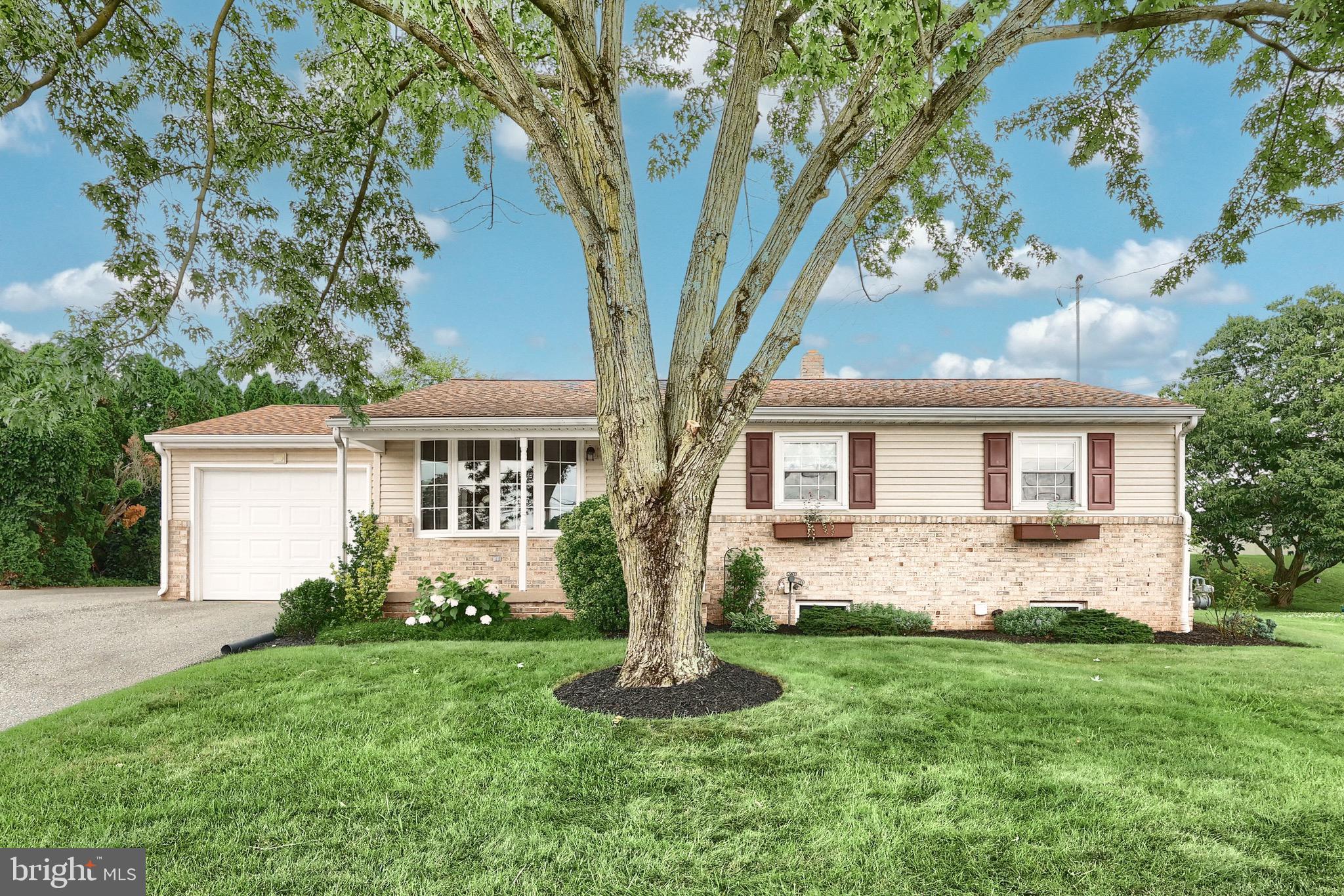 2569 Emig Mill Road Dover, PA 17315 - Photo 3 of 32 a front view of a house with a garden and yard