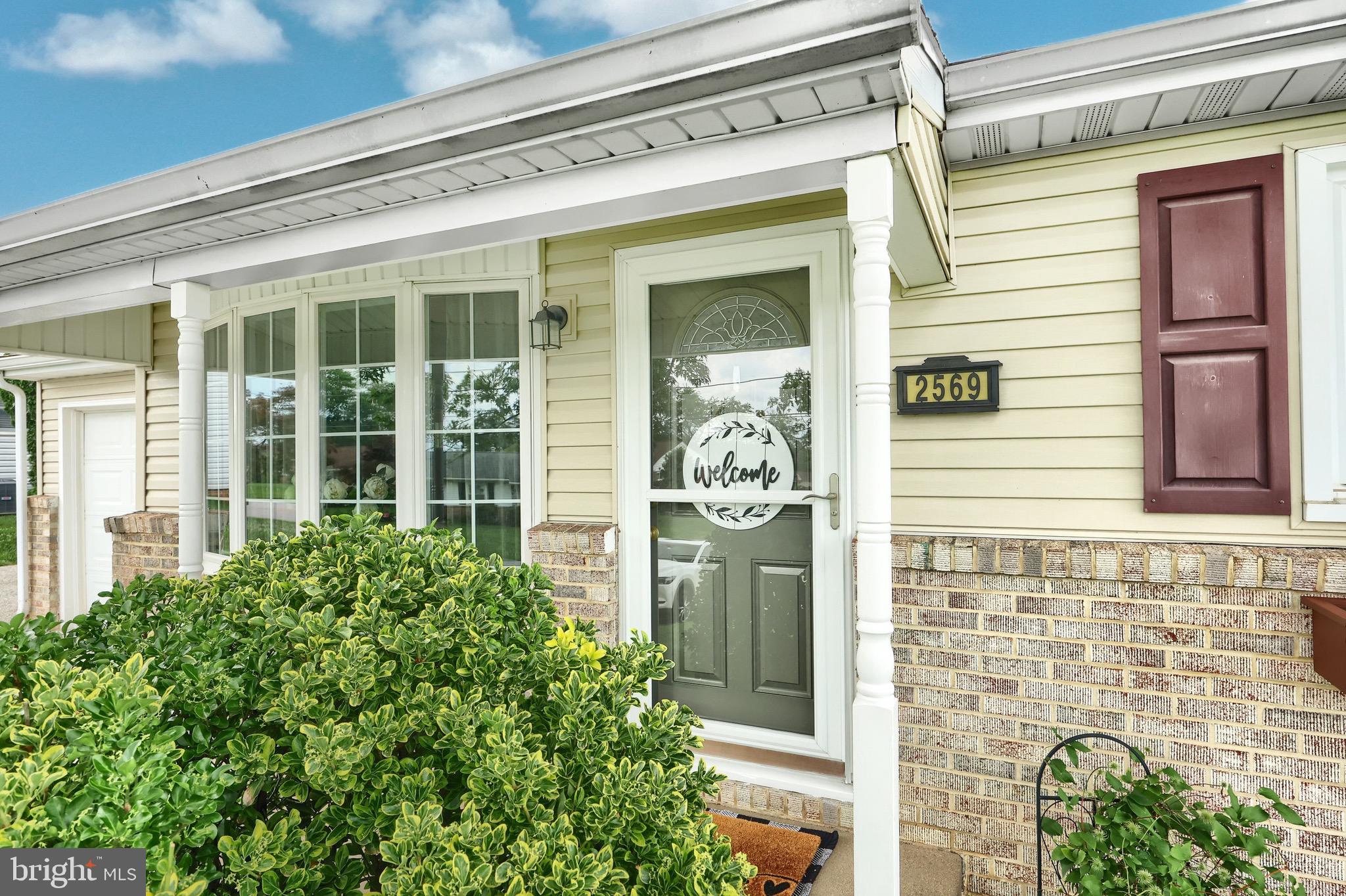 2569 Emig Mill Road Dover, PA 17315 - Photo 6 of 32 a front view of a house with a potted plant and a window