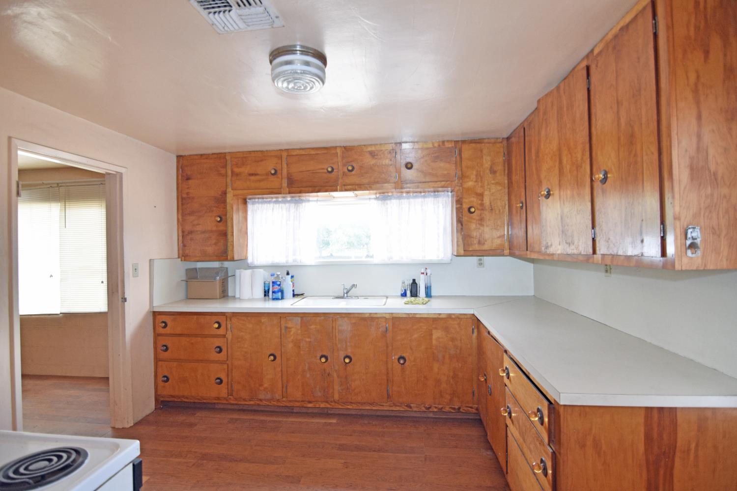 1206 South Verduga Road Turlock, CA 95380 - Photo 12 of 36 a kitchen with a sink a window and cabinets