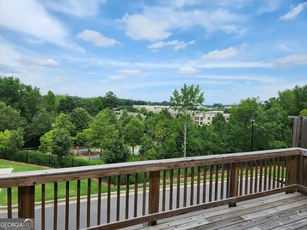 a balcony with wooden floor and city view