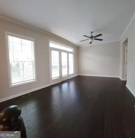 a view of wooden floor and windows in a room