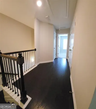a view of a hallway with wooden floor