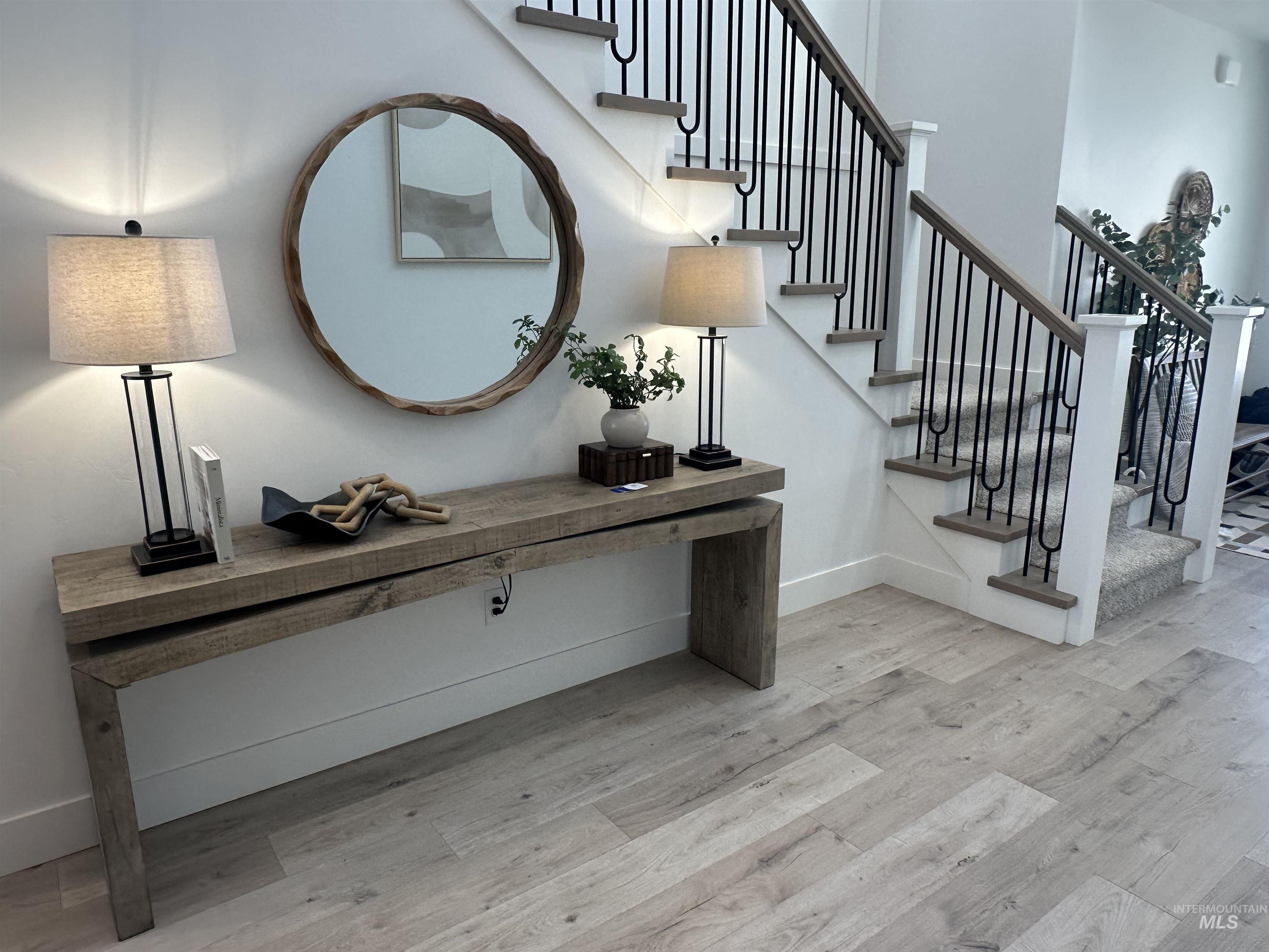 3035 Lake View Twin Falls, ID 83301 - Photo 41 of 41 Entryway featuring light wood-finish flooring and a staircase with black metal balusters