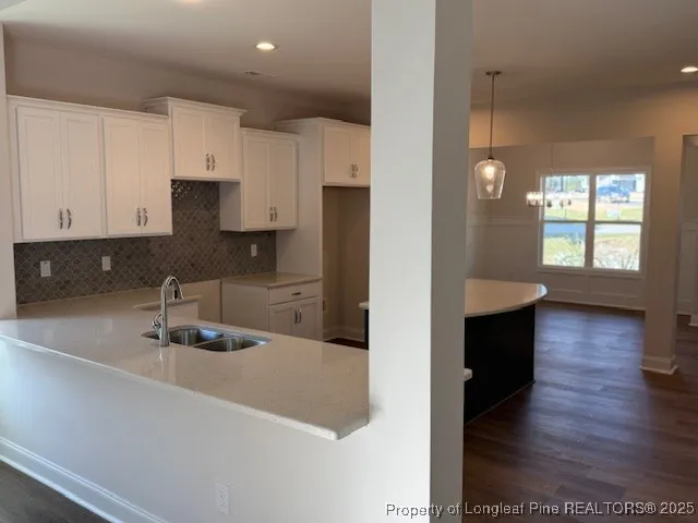 a kitchen with stainless steel appliances granite countertop a sink refrigerator and cabinets