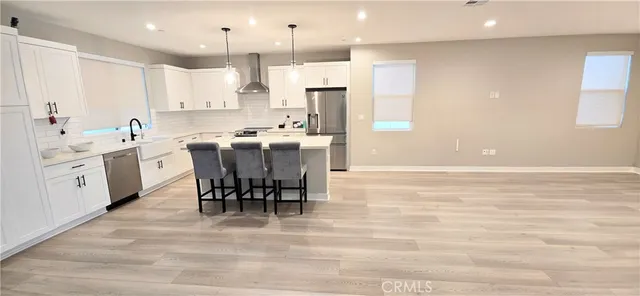 a kitchen with appliances a sink and a stove