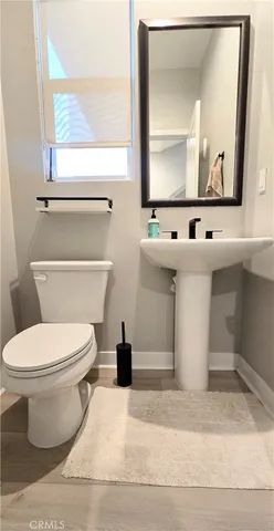 a white toilet sitting next to a bathroom sink