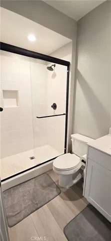 a view of a room with wooden floor and door