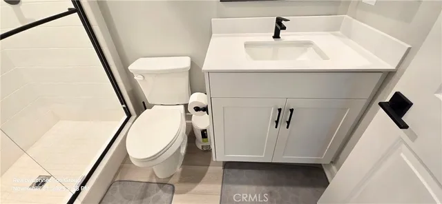 a view of a room with wooden floor and white walls