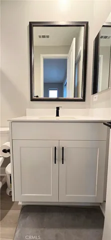 a bathroom with a sink a mirror and a shower