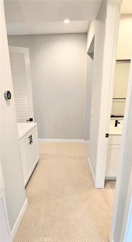 a spacious bathroom with a double vanity sink mirror and bathtub