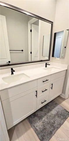 a bathroom with a tub sink a mirror and shower