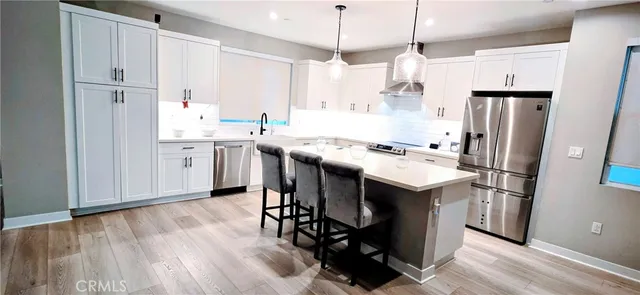 a kitchen with stainless steel appliances kitchen island granite countertop a sink and cabinets