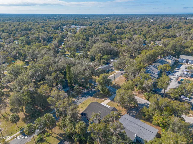 an aerial view of a house with a yard