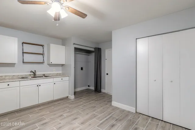 a spacious bathroom with a granite countertop sink a mirror and a shower