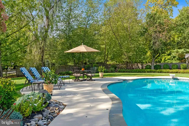 a view of a swimming pool with chairs in patio
