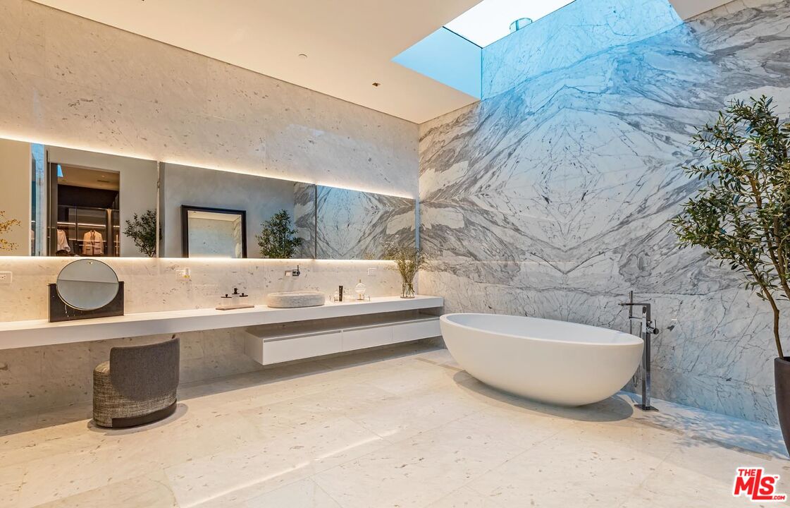 1108 Wallace Ridge Beverly Hills, CA 90210 - Photo 12 of 33 a bathroom with a tub a double vanity sink and mirror