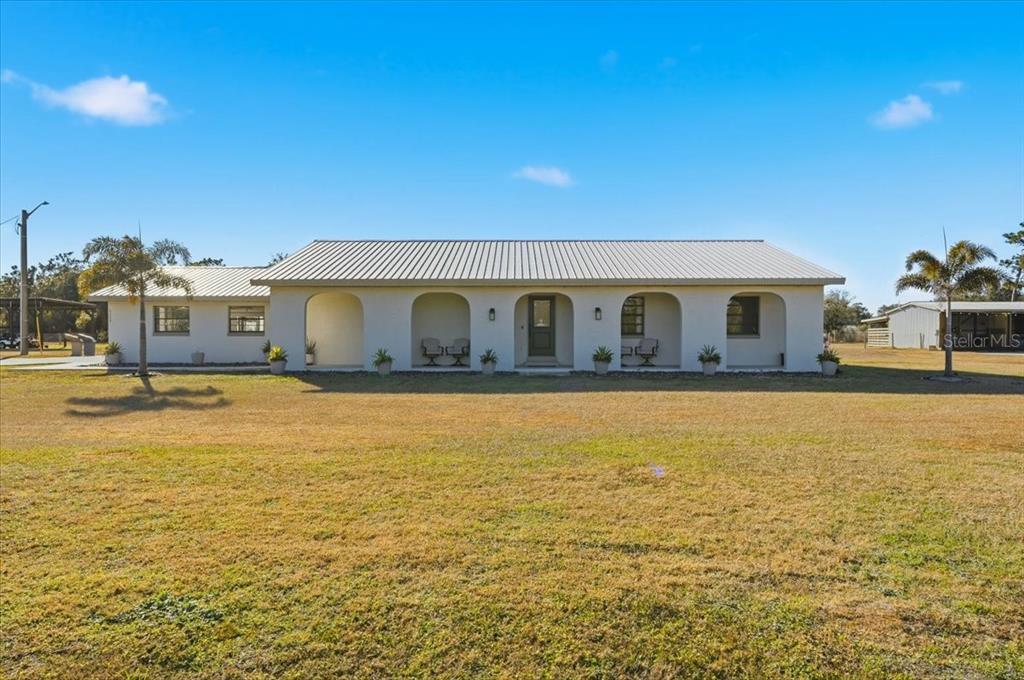 a house view with swimming pool in front of it