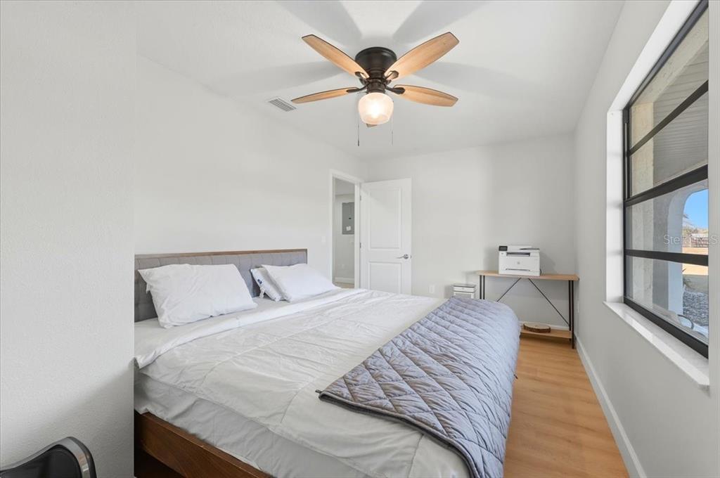 3454 Rambler Avenue St. Cloud, FL 34772 - Photo 11 of 24 a bedroom with a bed and a chandelier