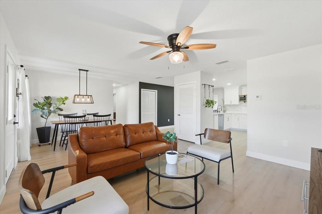 3454 Rambler Avenue St. Cloud, FL 34772 - Photo 4 of 24 a living room with furniture and a chandelier