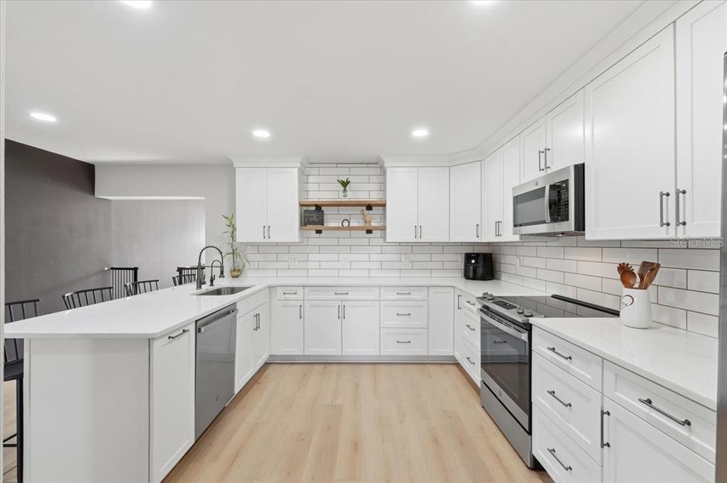 3454 Rambler Avenue St. Cloud, FL 34772 - Photo 6 of 24 a kitchen with a sink stove cabinets and refrigerator