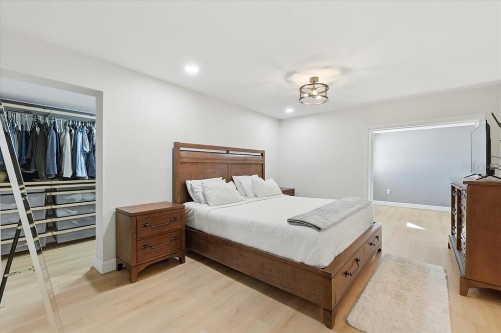 3454 Rambler Avenue St. Cloud, FL 34772 - Photo 7 of 24 a bedroom with a bed and a flat tv screen on wall