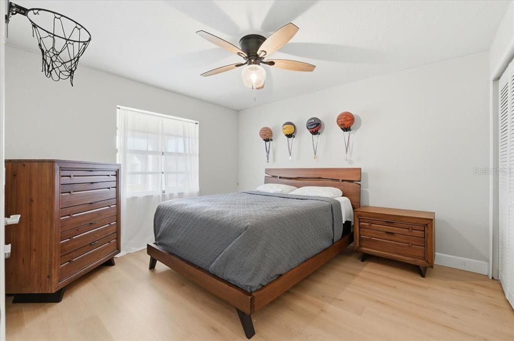 3454 Rambler Avenue St. Cloud, FL 34772 - Photo 10 of 24 a bedroom with a bed and a ceiling fan