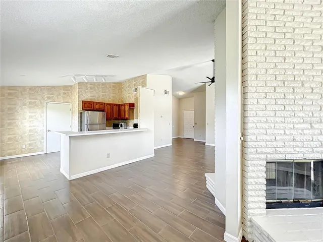 a view of a living room a window and a fireplace