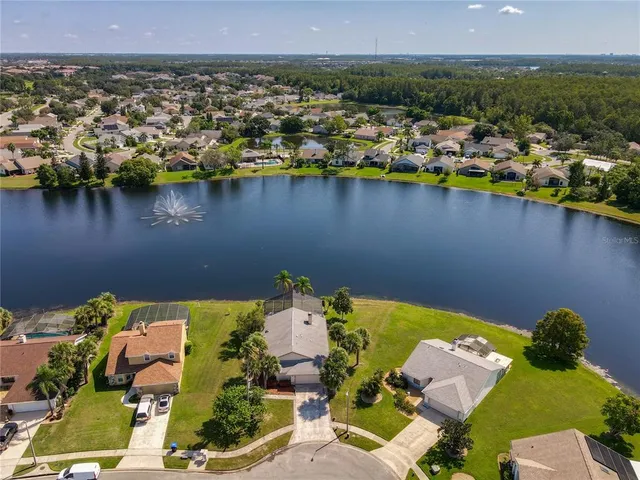 an aerial view of a house with a lake view