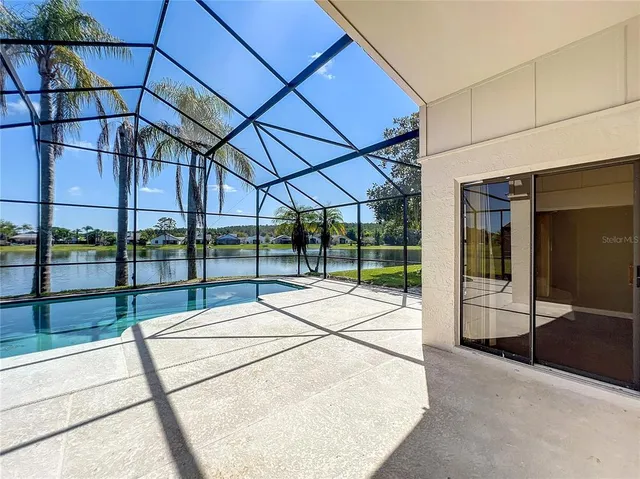 a view of a patio with a table and chairs under an umbrella