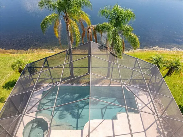 a bathroom with a glass shower door and window