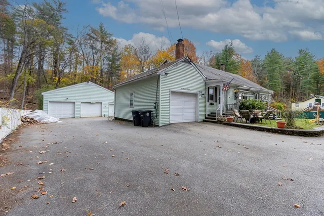 a view of a house with a yard and garage
