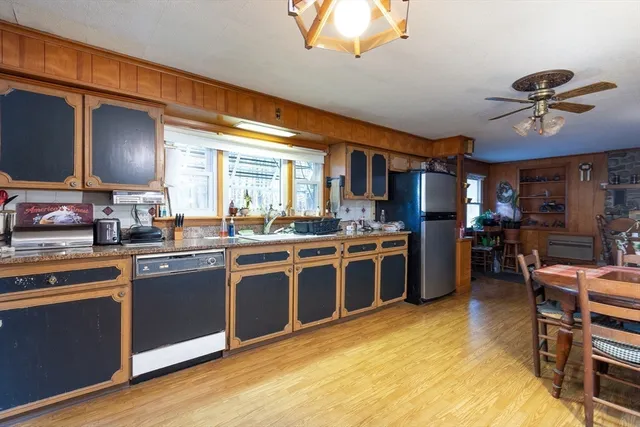 a kitchen with stainless steel appliances granite countertop a stove and a refrigerator